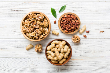 Walnut kernel halves, in a wooden bowl. Close-up, from above on colored background. Healthy eating Walnut concept. Super foods with copy space