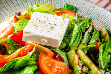 greek salad with cheese, tomato, olive, pepper, onion