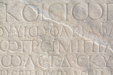 Historical inscription. Fragment of ancient law (imperial edict at Ancient Greek language), carved on marble block. Ancient art and history concept. Retro text background. Kayseri, Turkey (Turkiye)