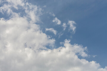 Fluffy cumulus clouds on the sky, nature atmosphere background