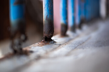 Corrosion on iron fence. Rusty metal fence. Steel pipes rust. The old metal structure got rust on surface and almost damage. Iron fence beginning to corrode. Old rusty fence.