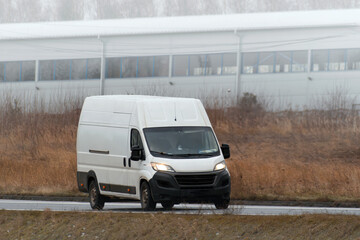 A white van with a blank wrap for your business branding and delivery service. Isolated mockup of a...