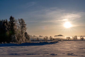 Sunshine over open fields covered in snow