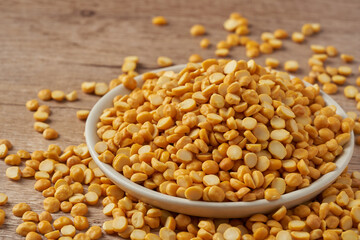 close up split bengal gram or chana dal in bowl on wood table rustic food background