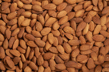 top view flat lay pile of peeled raw almond nut seed texture food background