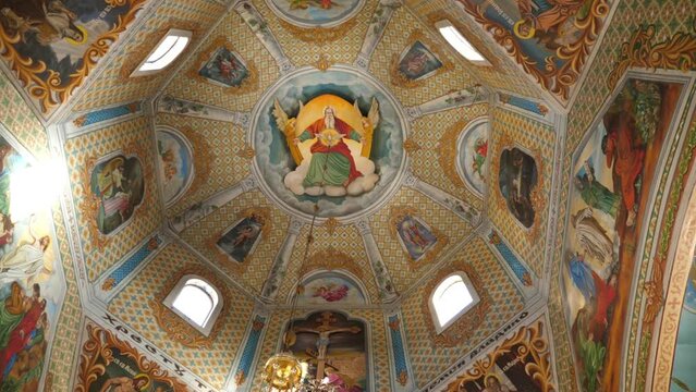 Painting of the dome in the middle of the church. Interior of the temple. Slow motion.