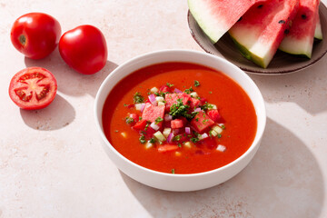 Spanish tomato and watermelon gazpacho cold soup styled and decorated in white plate