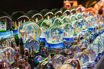 Glass souvenir snow balls with miniature Blue Mosque and Hagia Sophia inside. Street shop with...