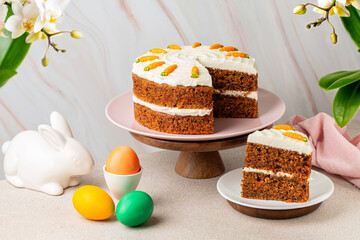 Easter table with carrot cake, Easter colorful eggs and bunny. Holiday homemade food, light...