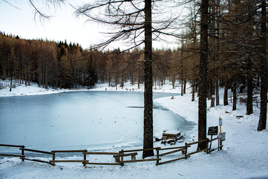 Winter mountain iced lake Il Lago della Ninfa. Monte Cimone, mountains in the northern Apennines, of Italy, Emilia-Romagna. Eco Sigh where is written about preservation of the lake and security.