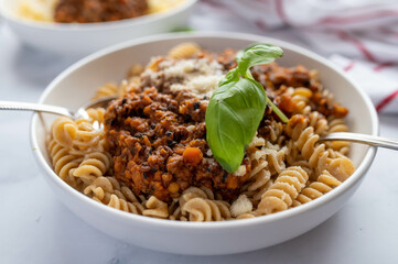 Vegetarian bolognese sauce with lentils and whole wheat pasta on a plate