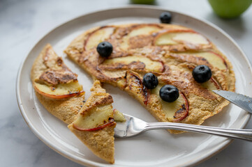 Oatmeal egg pancakes with apples on a plate
