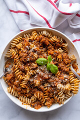 Vegetarian bolognese sauce with lentils and whole wheat pasta on a plate