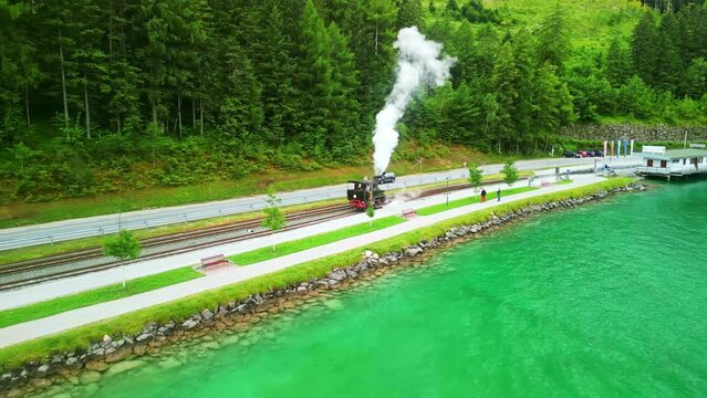 cog railway steam train on Achen Lake Achensee in Austrian Alps. popular tourist sightseeing destination in Tyrol region. Drone aerial view 