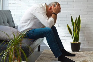 depressed middle aged man in his apartment