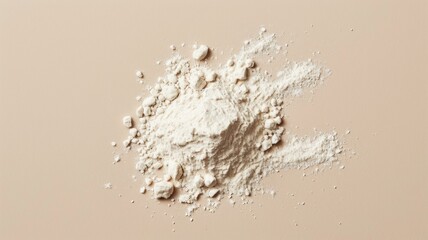 White flour on the beige background. Baking powder.
