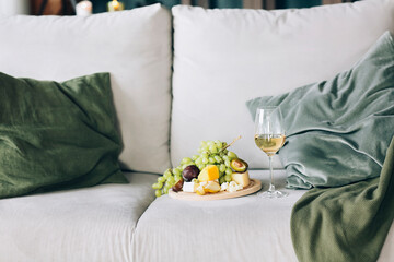 Fruits and wine on sofa at home