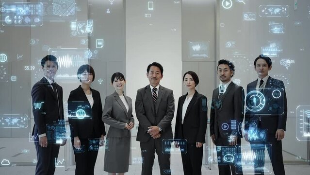 オフィスに立つビジネスパーソンのグループとデジタルテクノロジー