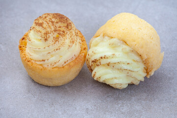 Mini South African milk tart cups on mottled grey with copy space and selective focus