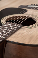 Fototapeta premium Classical guitar close up. Acoustic guitar on wood background.Music instrument concept