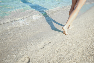 A Feet and footprints by the seashore in nature travel vacation background