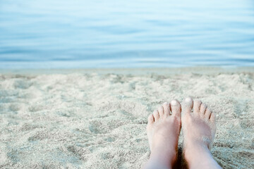 A beautiful legs on the sand by the sea