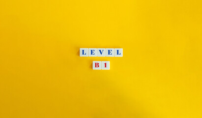 Level B1 Word and Banner. Block Letter Tiles on Yellow Background. Minimalist Aesthetic.