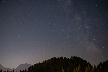 Fototapeta na wymiar starry sky in summer mountains and milky way Trentino Alps