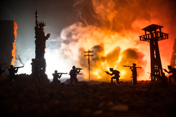 Conceptual image of war between Democracy and dictatorship using toy soldiers. Battle in ruined...