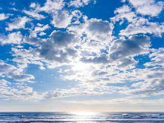 輝く海面と青空に浮かぶ白い雲