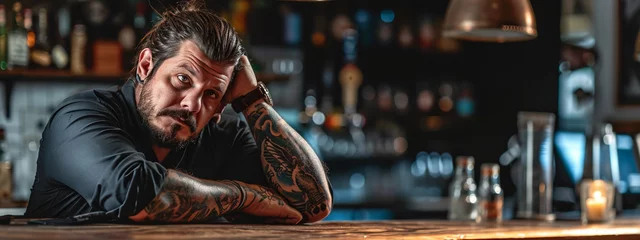 Foto op Plexiglas a man in a tattoo relaxes in a bar © Anna