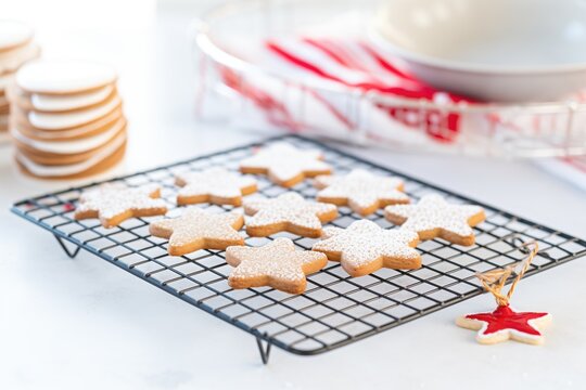 linzer cookies with raspberry jam on a wire rack