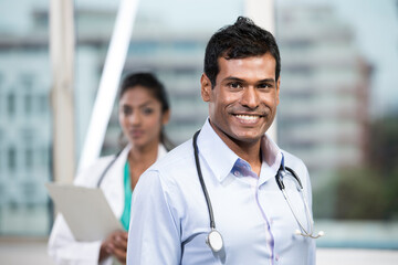 Male Indian doctor standing with his colleague