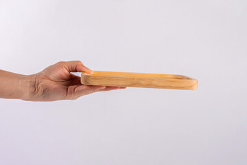 Wooden plate in hand on white background.