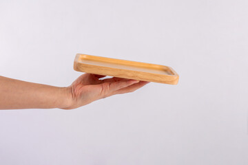 Wooden plate in hand on white background.