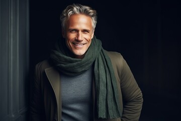 Portrait of a handsome middle-aged man in a coat and scarf.