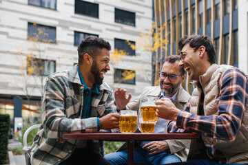 Best friends togehter, drinking beer and talking in bar in city. Concept of male friendship,...