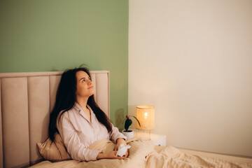 Sick woman sneezing in paper tissue on sofa