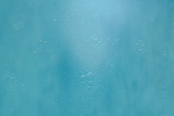 Air bubbles in the water background.Abstract oxygen bubbles in the sea.Water bubbles isolate on blue background.Sunlight underwater with bubbles rising to water surface in the ocean.