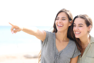 Happy woman showing something away to a friend