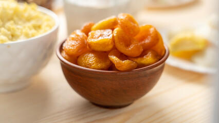 Dried apricots in clay cup. Food without animal fats, top view, Healthy food