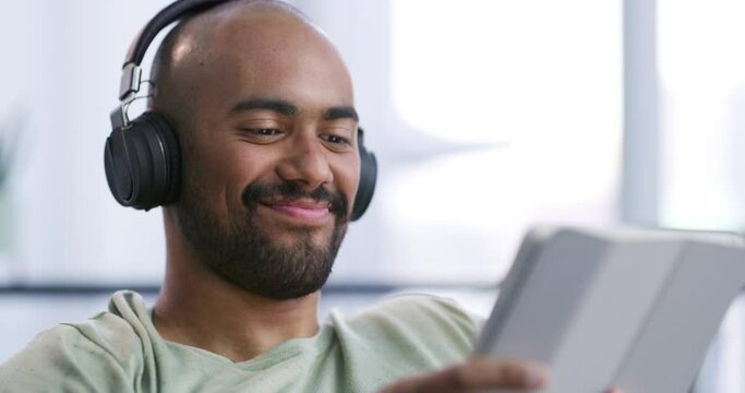 Man, tablet with headphones and listening to music at home, playlist or video with streaming and dancing. Radio, song or movie with internet and connection, online and technology for stress relief