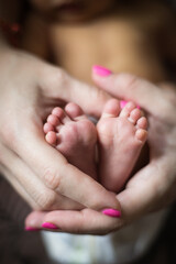 newborn baby feet in mom's hands