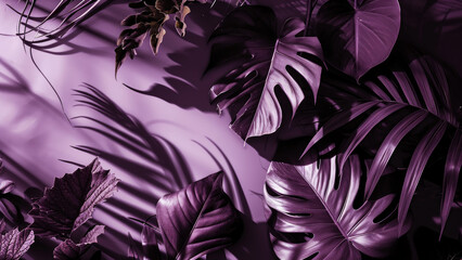 A monochromatic image of tropical leaves in various shades of violet purple with soft shadows on a matching background top view