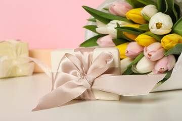 A bouquet of fresh tulips on a light background