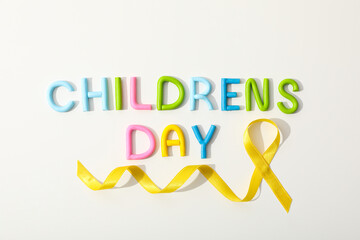 The inscription Children's Day with a yellow ribbon