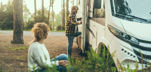 Couple enjoy travel destination in free parking in the mountain woods. Woman sitting  relaxing, man...