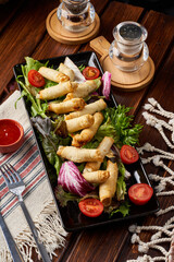 Fried borek dish with salad and tomatoes