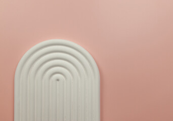 Top view of white arch tray on pink background. Geometric abstract shape for cosmetic product presentation. Copy space.