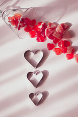 Valentine's day concept with red hearts and candies on wooden table